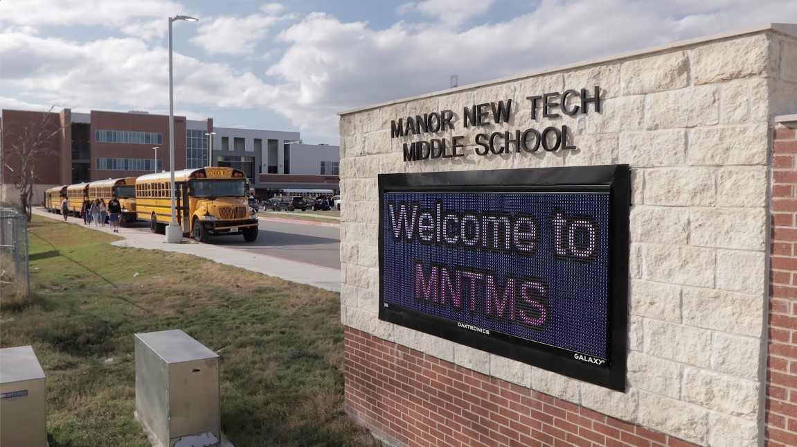 Image of Manor Independent School District sign and bus