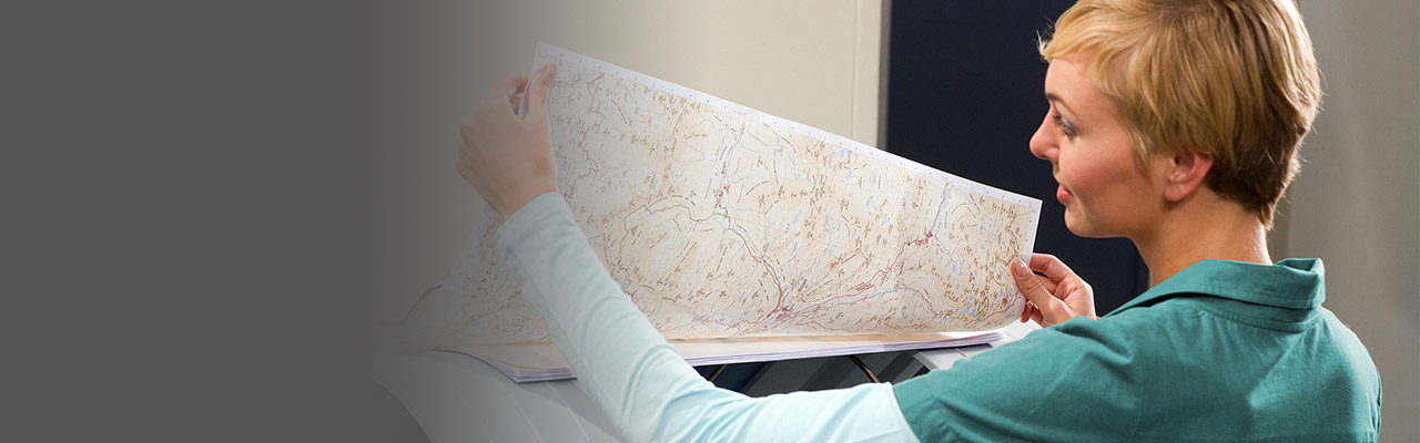 image of a woman reviewing GIS printed materials
